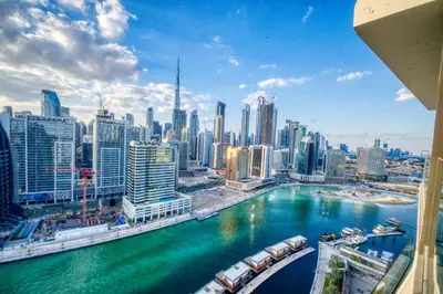 a view of a city with a river and buildings at AWS Holiday Homes - Dreamful Views of the Burj in Dubai
