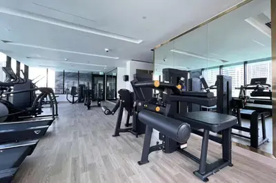 a gym with several treadmills and mirrors at AWS Holiday Homes - Dreamful Views of the Burj in Dubai