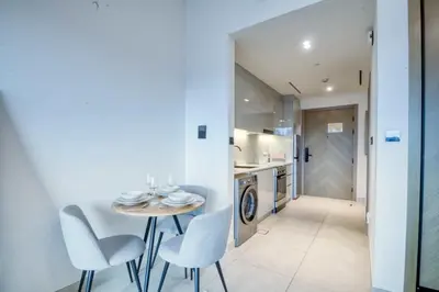 a kitchen and dining room with a table and chairs at AWS Holiday Homes - Dreamful Views of the Burj in Dubai