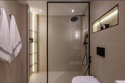 a bathroom with a shower with a glass door at 85m2 En Suite, DIFC in Dubai