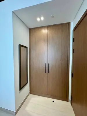 a room with two wooden cabinets and a mirror at Chic & Modern 1br In Jvc With Full Amenities in Dubai