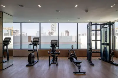 a gym with several exercise equipment in a building at Chic & Modern 1br In Jvc With Full Amenities in Dubai