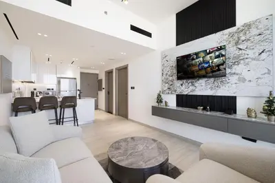 a living room with a couch and a table at Daniels Stylish 1BR Apartment with Al khail View in Dubai