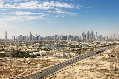 an aerial view of the city of dubai with a city skyline at Daniels Stylish 1BR Apartment with Al khail View in Dubai