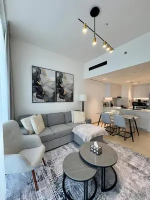 a living room with a couch and a table at New 1br Apt Jvc Pool View, Balcony & Parking in Dubai