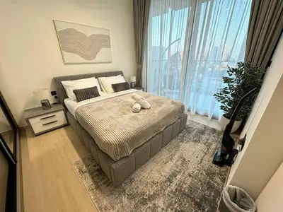a bedroom with a bed and a large window at New 1br Apt Jvc Pool View, Balcony & Parking in Dubai