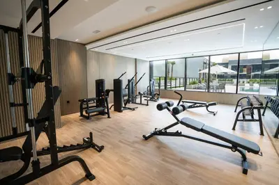 a gym with several treadmills and exercise bikes at New 1br Apt Jvc Pool View, Balcony & Parking in Dubai