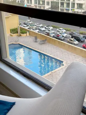 a view of a swimming pool from a hotel room window at Modern Marina Escape 4BR Family Retreat at JBR in Dubai