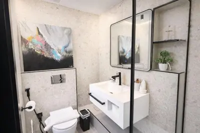 a bathroom with a white sink and a mirror at Modern Marina Escape 4BR Family Retreat at JBR in Dubai