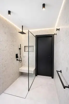 a bathroom with a black door and a staircase at Modern Marina Escape 4BR Family Retreat at JBR in Dubai