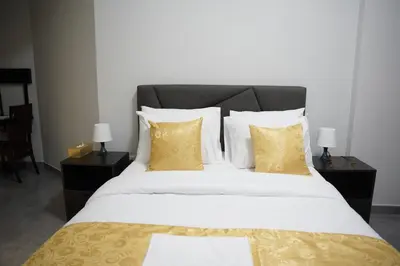 a bedroom with a large bed with yellow pillows at Ista Vacation Homes Rental LLC KARAMA in Dubai