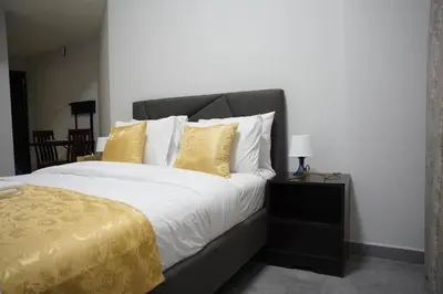 a bedroom with a large bed with yellow pillows at Ista Vacation Homes Rental LLC KARAMA in Dubai