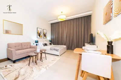 a living room with a couch and a table at Splendid City Views Studio- SOL BAY Business Bay in Dubai