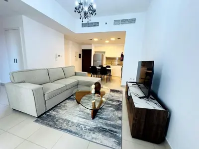 a living room with a couch and a coffee table at 02 Bedroom Apartment in Townsquare in Dubai