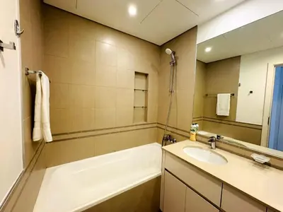a bathroom with a bath tub and a sink at 02 Bedroom Apartment in Townsquare in Dubai