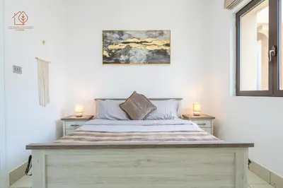 a bedroom with a large bed with two night stands at Cozy Old Town 2-Bed Apartment with Burj Khalifa Views 202RH-2 in Dubai