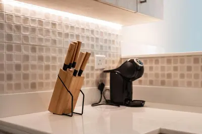 a kitchen counter with a knife block on it at 1BR Palm Jumeirah - Rooftop Pool & Beach Access in Dubai