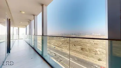 a glass corridor in a building with a view at Spacious 3BR Apartment in Dubai