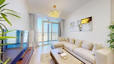 a living room with a couch and a tv at Spacious 3BR Apartment in Dubai