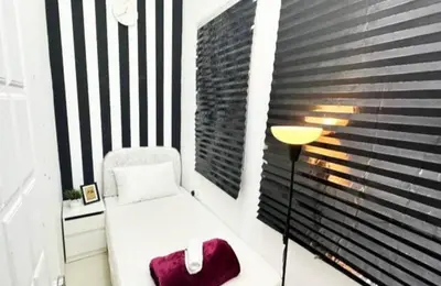 a white chair in a room with a window at Partitioned Single Room in Al Barsha 1 Near Metro in Dubai