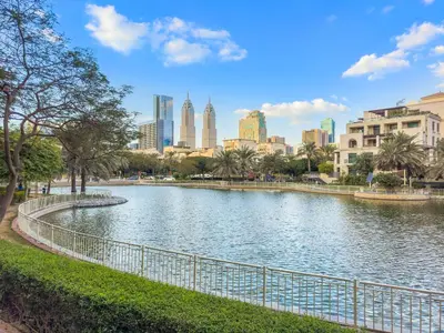 a river with a city in the background at Cozy Studio with Scenic Canal Views in Dubai