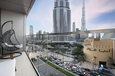 a view of a city from a balcony in a building at Luxe 1BR with Full Burj Views and Dubai Mall Access in Dubai