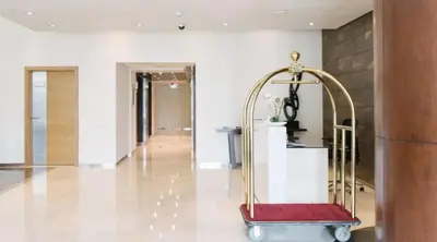 a lobby with a red and gold luggage cart at Luxury 2-bed Condo Full Burj Khalifa Lights View! in Dubai