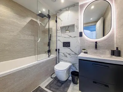 a bathroom with a toilet and a sink and a mirror at Luxury 2-bed Condo Full Burj Khalifa Lights View! in Dubai
