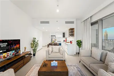 a living room with a couch and a tv at Elegant 2BR in Downtown Dubai l Walk to Dubai Mall in Dubai