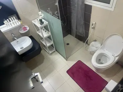 a bathroom with a toilet and a sink and a shower at Cozy Studio- Dubai Marina in Dubai