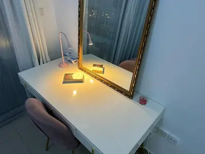 a dressing table with a mirror and a chair at Studio Apartment- Dubai Marina in Dubai