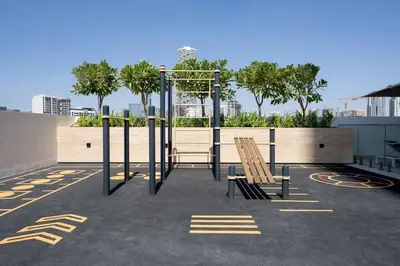 a playground with two wooden chairs in a parking lot at Modern & Elegant 1br Apartment In Jvc in Dubai