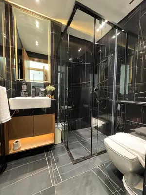 a bathroom with a shower and a toilet and a sink at Modern & Elegant 1br Apartment In Jvc in Dubai