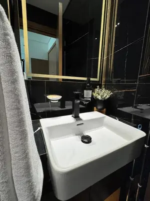 a bathroom with a white sink and a mirror at Modern & Elegant 1br Apartment In Jvc in Dubai