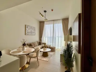 a living room with a couch and a table at Chic Urban 1br In Jvc With Modern Amenities in Dubai