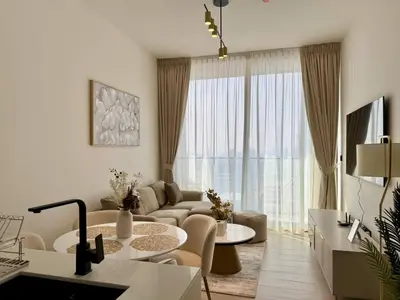 a living room with a couch and a table at Chic Urban 1br In Jvc With Modern Amenities in Dubai