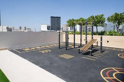 a playground with a bench on top of a building at Chic Urban 1br In Jvc With Modern Amenities in Dubai