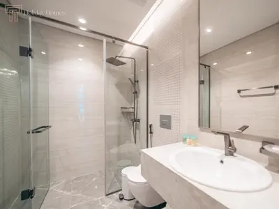 a bathroom with a sink and a glass shower at Stunning One Bed Apartment In Luxury Tower in Dubai