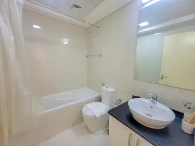 a bathroom with a sink and a toilet and a mirror at Damac Park Central - Blue Ocean Holiday Homes in Dubai