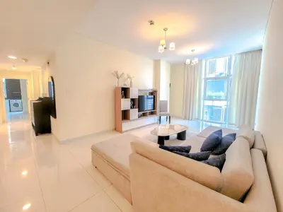 a living room with a couch and a tv at Damac Park Central - Blue Ocean Holiday Homes in Dubai