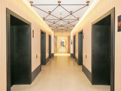 a hallway with black doors and a long hallway with a hallwayngth at Luxury Living , Beautiful Layout in Dubai