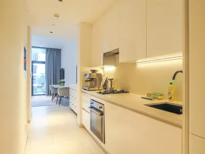 a kitchen with a sink and a counter top at Luxury Living , Beautiful Layout in Dubai