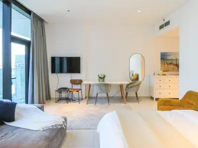 a living room with a table and a mirror at Luxury Living , Beautiful Layout in Dubai