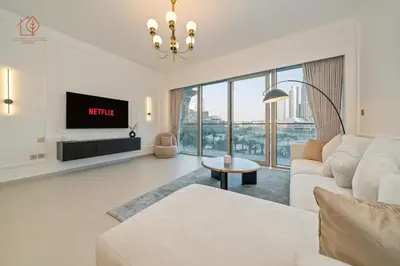 a living room with a couch and a tv at Burj Khalifa Views 2-Bedroom Apartment 203GR-2 in Dubai