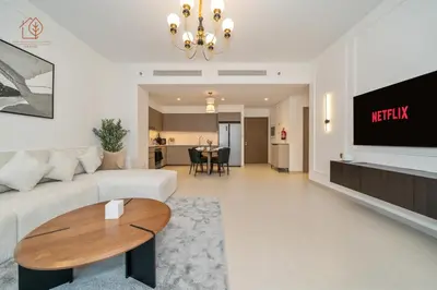 a living room with a couch and a table at Burj Khalifa Views 2-Bedroom Apartment 203GR-2 in Dubai