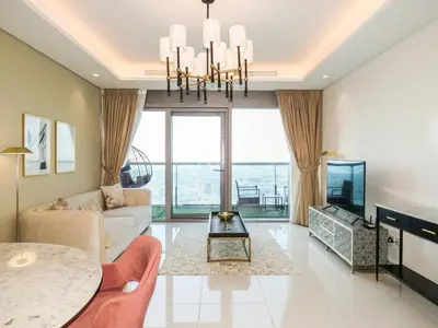 a living room with a couch and a table at High Floor , Premium 1 Bedroom , Stunning Views in Dubai