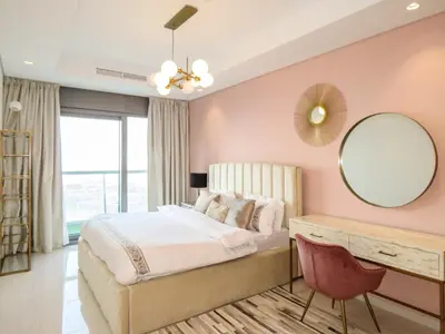 a bedroom with a bed and a mirror and a desk at High Floor , Premium 1 Bedroom , Stunning Views in Dubai
