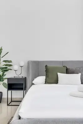 a bedroom with a white bed and a side table at GuestReady - Dubai Marina retreat with balcony in Dubai