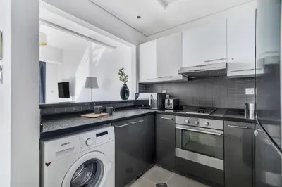 a kitchen with a washer and a dishwasher at GuestReady - Dubai Marina retreat with balcony in Dubai