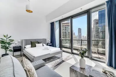 a living room with a bed and a large window at GuestReady - Dubai Marina retreat with balcony in Dubai